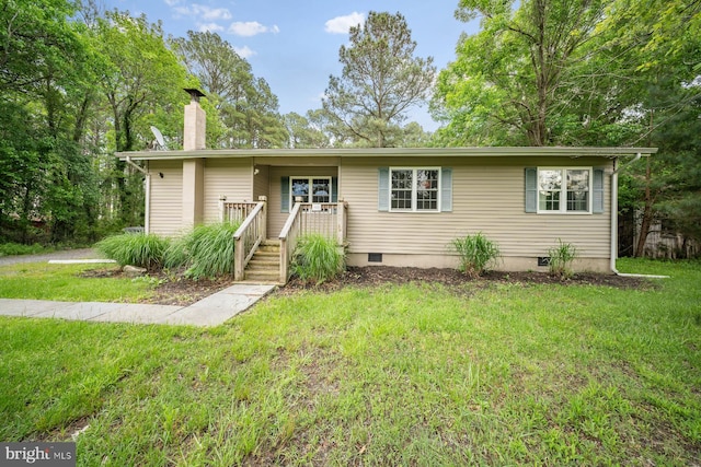 1211 Mcglaughlin Rd, Fishing Creek, MD 21634 - view of front of property with a front yard, a chimney, and crawl space