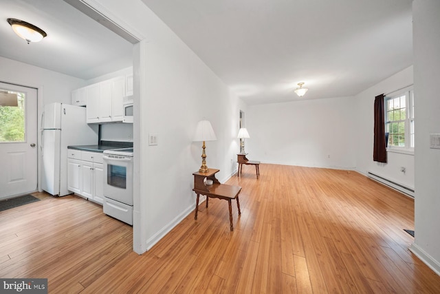 1211 Mcglaughlin Rd, Fishing Creek, MD 21634 - kitchen with baseboard heating, white appliances, white cabinets, and light wood-type flooring