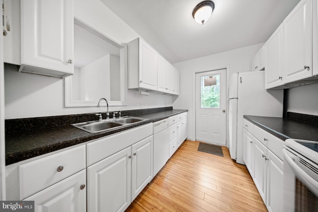 1211 Mcglaughlin Rd, Fishing Creek, MD 21634 - kitchen with a sink, white appliances, white cabinetry, dark countertops, and light wood-type flooring