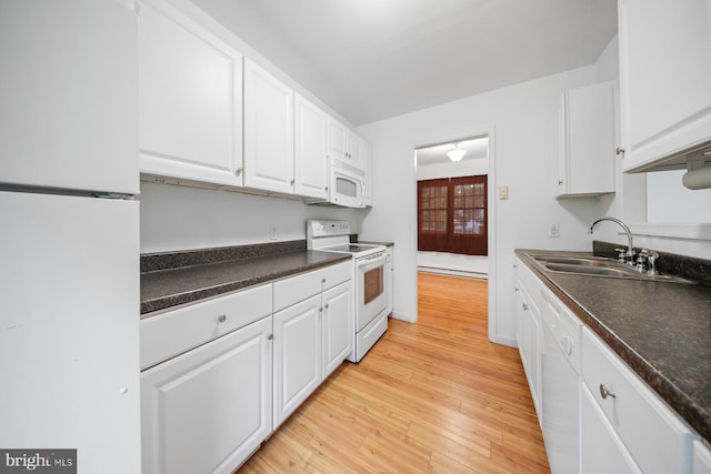 1211 Mcglaughlin Rd, Fishing Creek, MD 21634 - kitchen with white appliances, a sink, white cabinetry, and light wood finished floors
