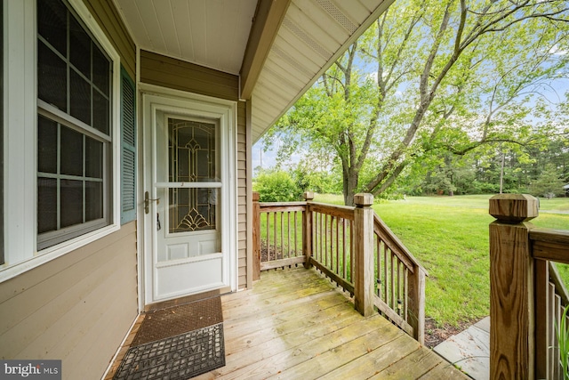 1211 Mcglaughlin Rd, Fishing Creek, MD 21634 - deck featuring a yard and view of wooded area