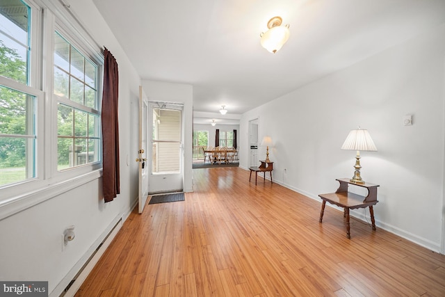 1211 Mcglaughlin Rd, Fishing Creek, MD 21634 - entrance foyer with baseboard heating, light wood-style floors, and baseboards