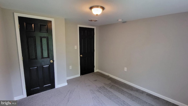 unfurnished bedroom with carpet flooring and baseboards