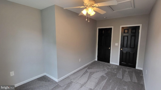 carpeted empty room with ceiling fan and baseboards
