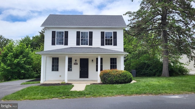 view of front of house with a porch and a front lawn