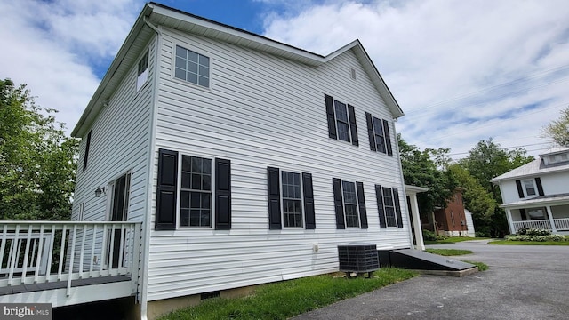 view of side of property featuring central AC unit and crawl space