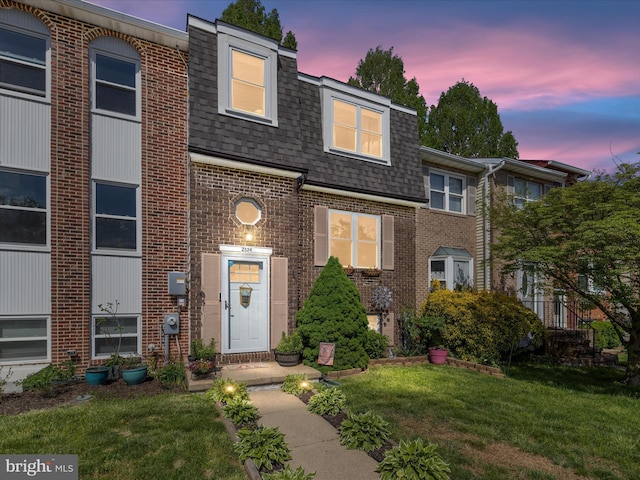 2524 Vineyard Ln, Crofton, MD 21114 - view of front of property with a shingled roof, brick siding, a front lawn, and mansard roof