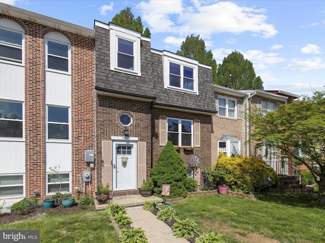 2524 Vineyard Ln, Crofton, MD 21114 - view of front of house featuring roof with shingles, brick siding, a front yard, and mansard roof