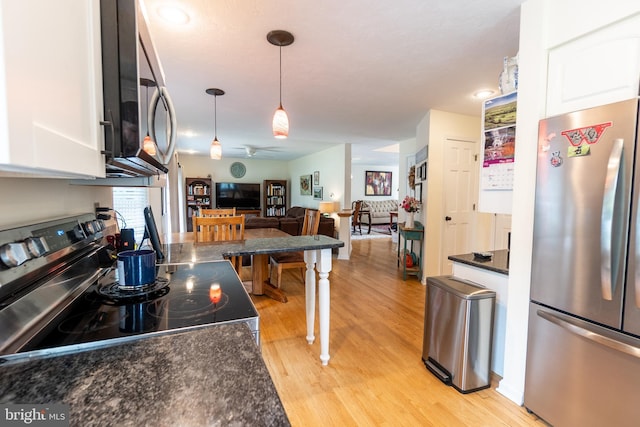 705 Hemlock Ct, Hanover, PA 17331 - kitchen featuring appliances with stainless steel finishes, dark countertops, white cabinets, open floor plan, and light wood finished floors