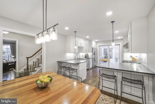 4831 Alton Pl NW, Washington, DC 20016 - dining room with dark wood-style floors, stairway, and recessed lighting