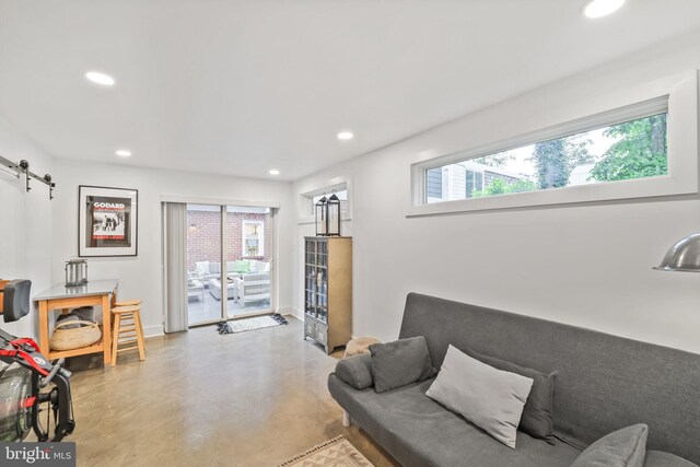 4831 Alton Pl NW, Washington, DC 20016 - living area featuring finished concrete floors, recessed lighting, a barn door, and baseboards
