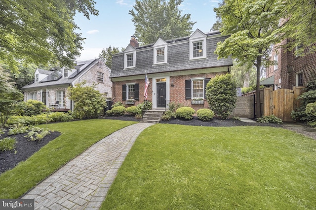 4831 Alton Pl NW, Washington, DC 20016 - front facade featuring a chimney, mansard roof, and brick siding