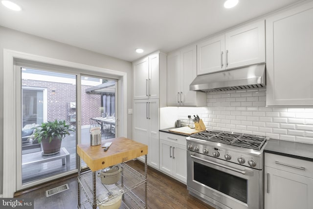4831 Alton Pl NW, Washington, DC 20016 - kitchen featuring stainless steel gas stove, under cabinet range hood, backsplash, dark wood-type flooring, and recessed lighting