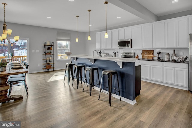 128 Fred Dr, North East, MD 21901 - kitchen featuring stainless steel appliances, a chandelier, recessed lighting, light wood-style flooring, and white cabinetry