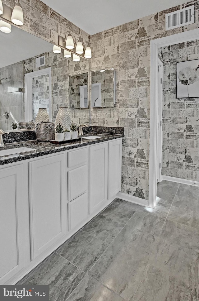 128 Fred Dr, North East, MD 21901 - bathroom featuring baseboards, double vanity, and tiled shower