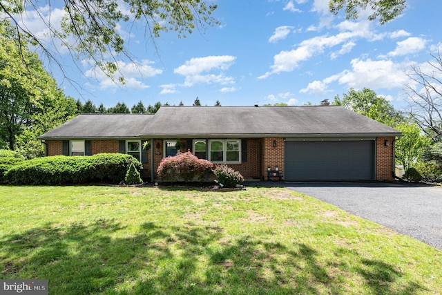ranch-style house featuring an attached garage, driveway, brick siding, and a front lawn