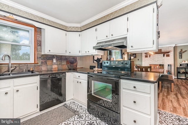 kitchen with black appliances, under cabinet range hood, crown molding, dark countertops, and a sink