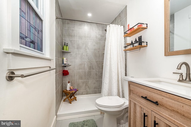 full bath featuring toilet, tiled shower, vanity, and tile patterned floors