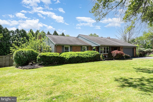 ranch-style home with a garage, asphalt driveway, and brick siding