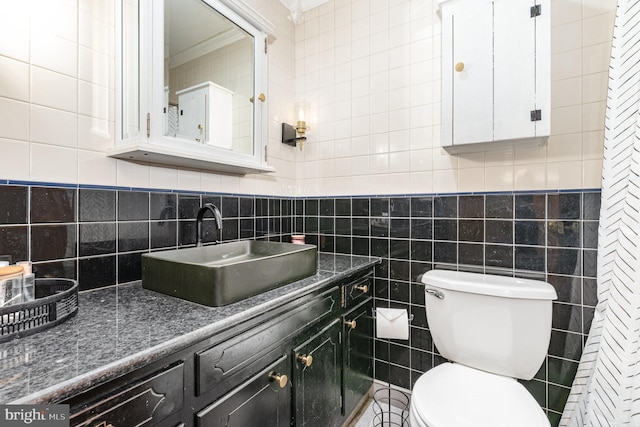 half bath featuring tile walls, toilet, and vanity