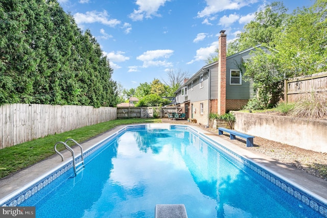 view of swimming pool featuring a fenced backyard and a deck