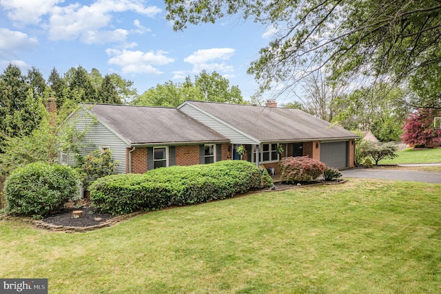 ranch-style home with driveway, a garage, brick siding, and a chimney