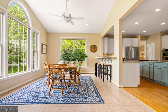 21381 Chickacoan Trail Dr, Broadlands, VA 20148 - dining room with vaulted ceiling, a ceiling fan, baseboards, light tile patterned floors, and recessed lighting