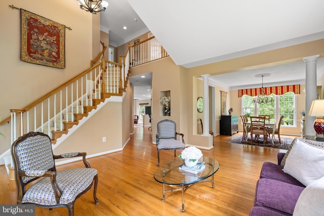 21381 Chickacoan Trail Dr, Broadlands, VA 20148 - living area with ornate columns, crown molding, stairs, wood finished floors, and a high ceiling