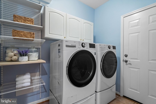 21381 Chickacoan Trail Dr, Broadlands, VA 20148 - laundry room featuring separate washer and dryer, cabinet space, light tile patterned flooring, and baseboards
