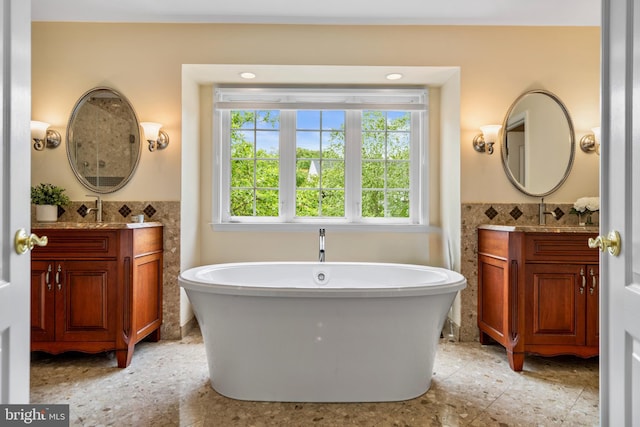 21381 Chickacoan Trail Dr, Broadlands, VA 20148 - full bath featuring a freestanding bath, two vanities, tile walls, and wainscoting