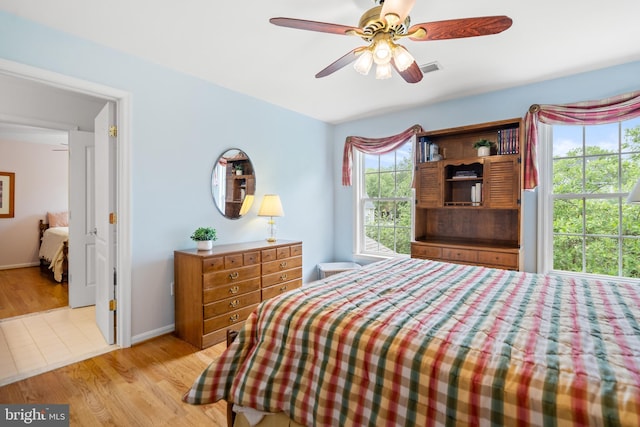 21381 Chickacoan Trail Dr, Broadlands, VA 20148 - bedroom with light wood-type flooring, baseboards, and a ceiling fan