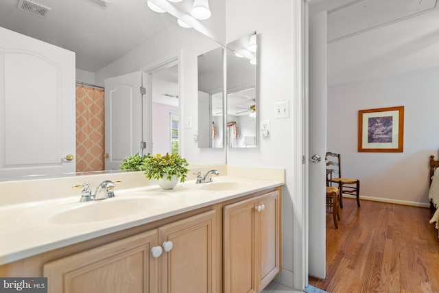 21381 Chickacoan Trail Dr, Broadlands, VA 20148 - bathroom with double vanity, wood finished floors, and a ceiling fan