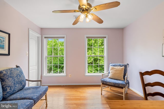 21381 Chickacoan Trail Dr, Broadlands, VA 20148 - living area with healthy amount of natural light, light wood finished floors, and baseboards