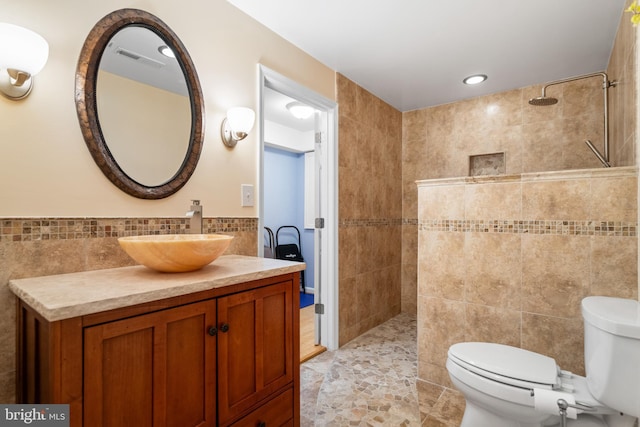 21381 Chickacoan Trail Dr, Broadlands, VA 20148 - bathroom featuring tile walls, a walk in shower, toilet, vanity, and tile patterned flooring