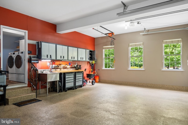 21381 Chickacoan Trail Dr, Broadlands, VA 20148 - garage featuring separate washer and dryer, a workshop area, a sink, and baseboards