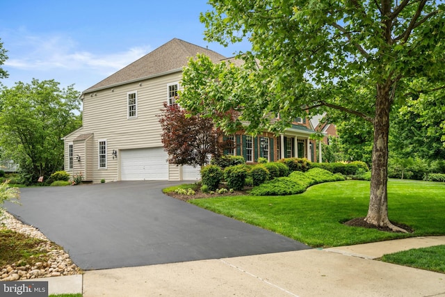 21381 Chickacoan Trail Dr, Broadlands, VA 20148 - view of front of home with asphalt driveway, a front lawn, an attached garage, and roof with shingles