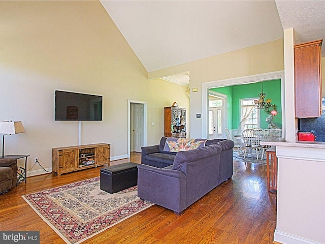 551 N Buckton Rd, Middletown, VA 22645 - living room featuring dark wood-style flooring, high vaulted ceiling, a chandelier, and baseboards