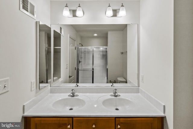 121 Stribling Way, Winchester, VA 22602 - bathroom with double vanity, a tile shower, and toilet