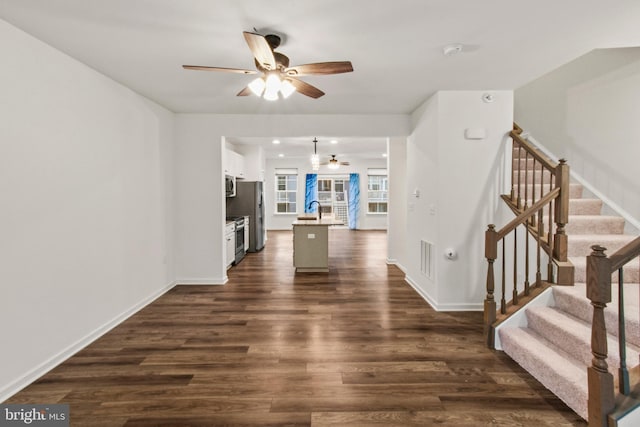 121 Stribling Way, Winchester, VA 22602 - unfurnished living room with ceiling fan, dark wood-type flooring, stairs, a sink, and baseboards