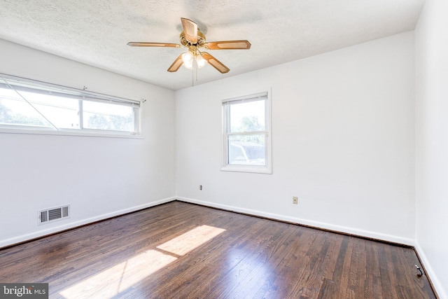 2 Idlewood St, Glen Burnie, MD 21061 - spare room with dark wood-style floors, healthy amount of natural light, baseboards, ceiling fan, and a textured ceiling