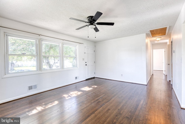 2 Idlewood St, Glen Burnie, MD 21061 - spare room with a textured ceiling, dark wood-style floors, baseboards, attic access, and ceiling fan