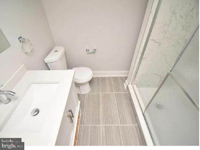 217 S E Ave S, Baltimore, MD 21224 - bathroom featuring vanity, toilet, a shower stall, and tile patterned flooring