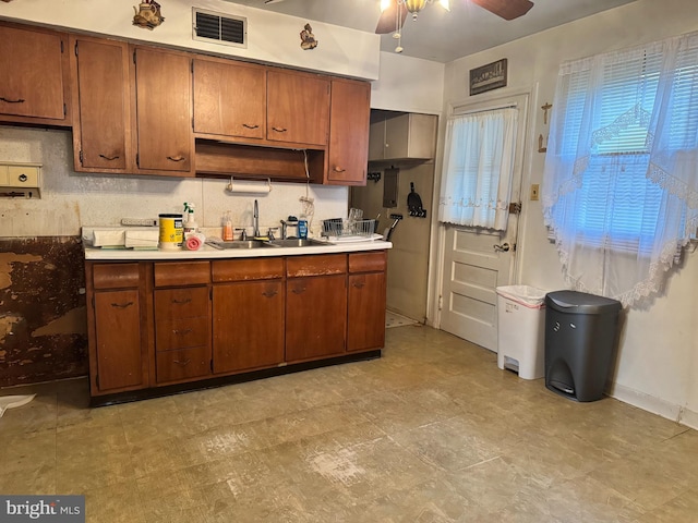 35 Farnsworth Ave, Maple Shade, NJ 08052 - kitchen featuring a sink, a ceiling fan, brown cabinets, and light countertops