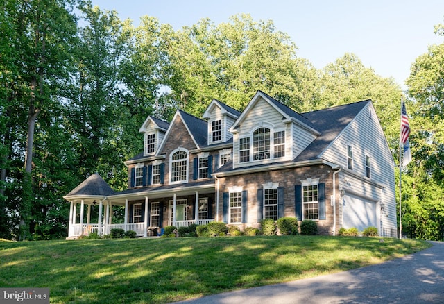 3565 Sauvignon Ln, Chesapeake Beach, MD 20732 - view of front of home with an attached garage, a porch, a front yard, and driveway