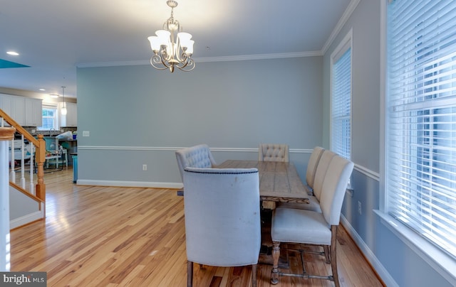 3565 Sauvignon Ln, Chesapeake Beach, MD 20732 - dining room with light wood-style flooring, a chandelier, ornamental molding, and baseboards