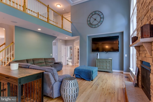 3565 Sauvignon Ln, Chesapeake Beach, MD 20732 - living room with a high ceiling, stairway, hardwood / wood-style flooring, a fireplace, and healthy amount of natural light