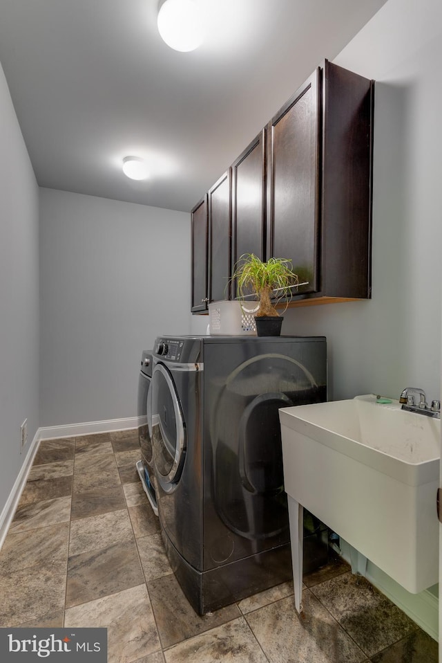 3565 Sauvignon Ln, Chesapeake Beach, MD 20732 - laundry room featuring cabinet space, separate washer and dryer, baseboards, and stone finish flooring