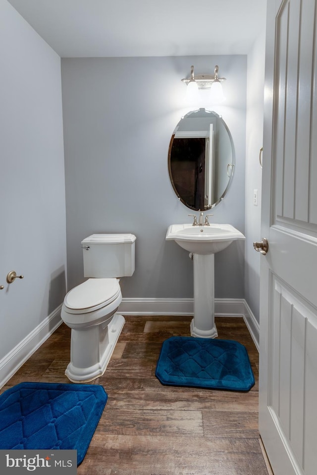 3565 Sauvignon Ln, Chesapeake Beach, MD 20732 - half bath with baseboards, wood finished floors, and toilet