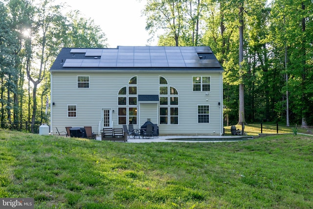 3565 Sauvignon Ln, Chesapeake Beach, MD 20732 - rear view of property featuring roof mounted solar panels and a patio area