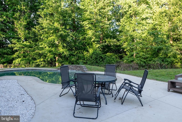 3565 Sauvignon Ln, Chesapeake Beach, MD 20732 - view of patio / terrace featuring outdoor dining area, an outdoor pool, and a view of trees